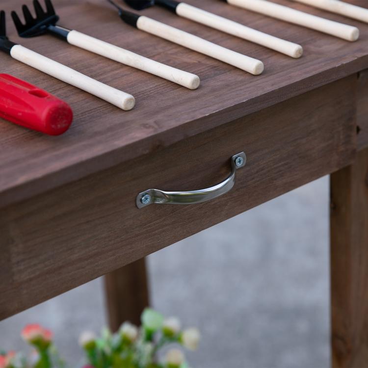 Wood potting bench drawer handle close-up with metal pull and wood grain