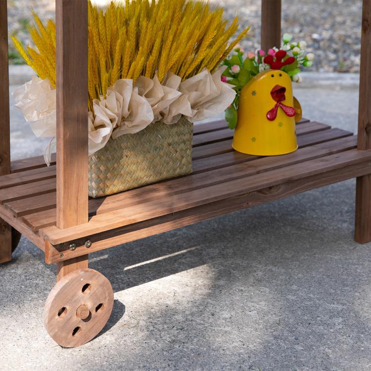 Wood potting bench lower shelf with decorative wheel and potted plants