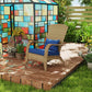 Rattan wicker Adirondack chair with dark blue seat and back cushions on wooden deck
