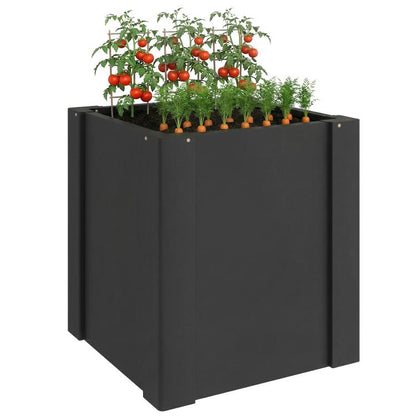 Black raised garden bed planter box with leafy seedlings and tomato plants on top