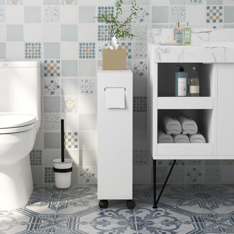 White slim toilet paper cabinet with sliding doors and caster wheels in a bathroom.