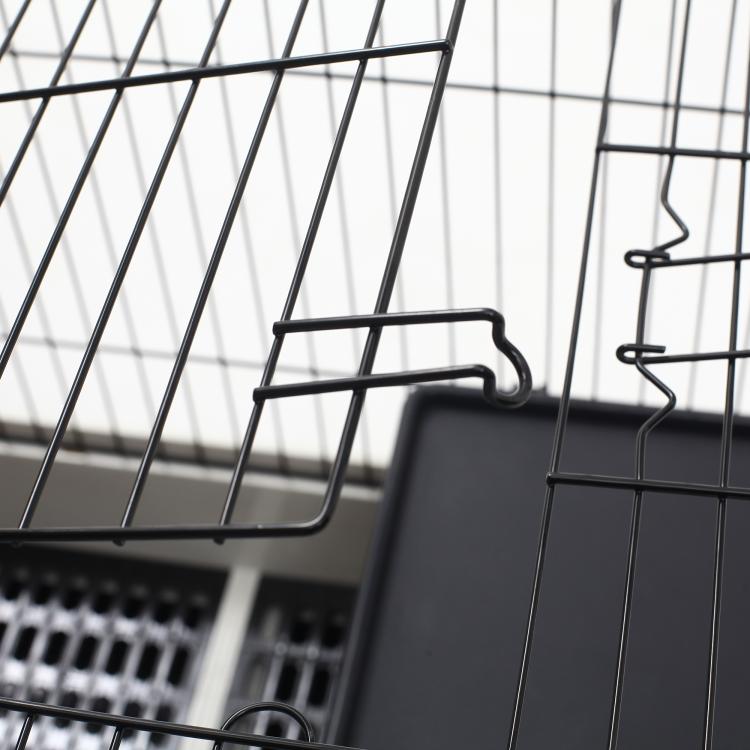 Black wire small animal cage with door latch and metal frame bars, close-up