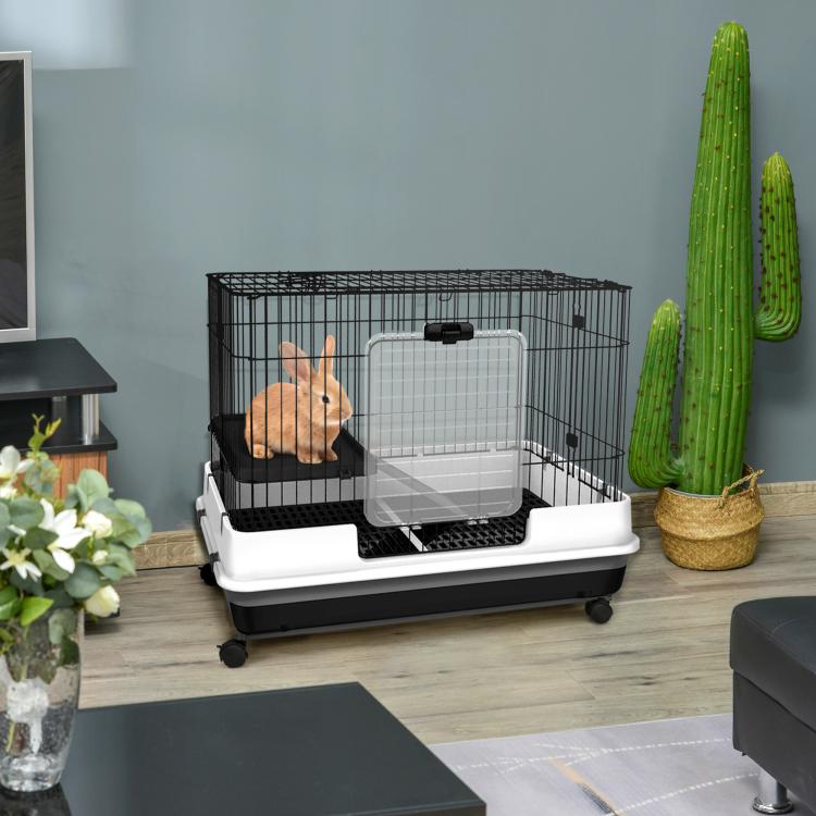 Wire rabbit hutch with black ramp and platform on rolling wheels, white base
