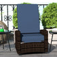 Outdoor wicker swivel recliner chair with dark brown woven sides and dark blue cushion back and seat