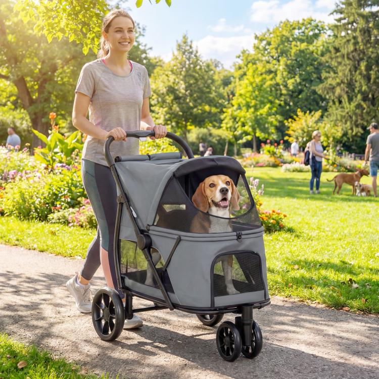 Gray 3-wheel pet stroller with mesh canopy window and padded interior on outdoor path