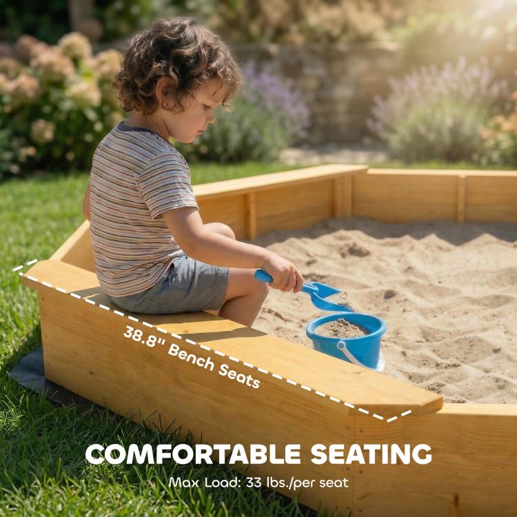 Yellow wooden bench seats around sand box with kids seated and playing.