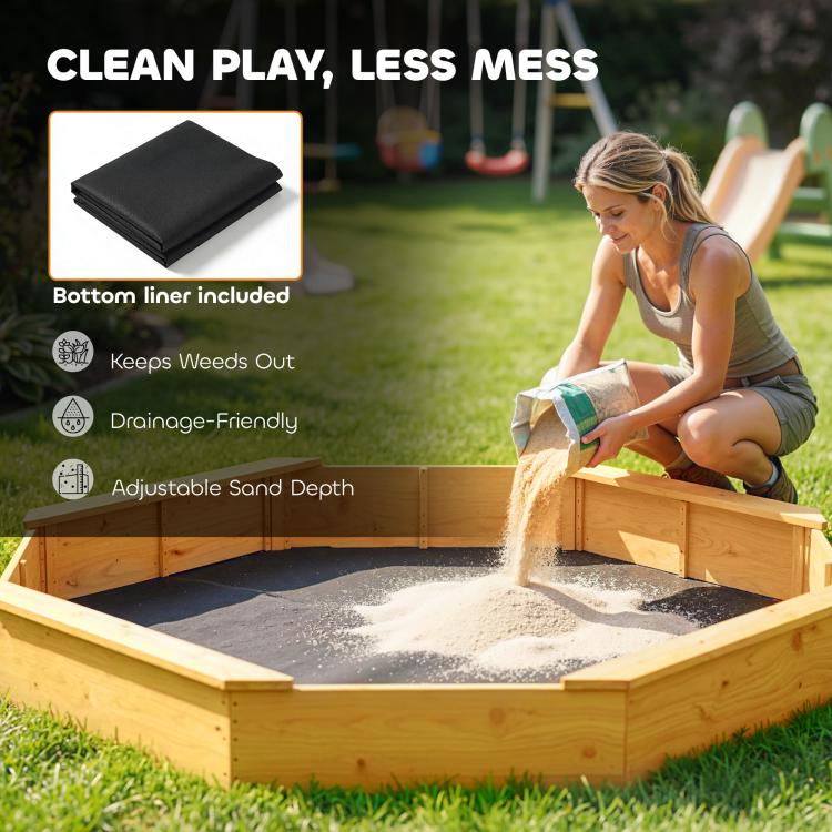 Yellow wooden sandbox with sand inside and black bottom liner underneath.