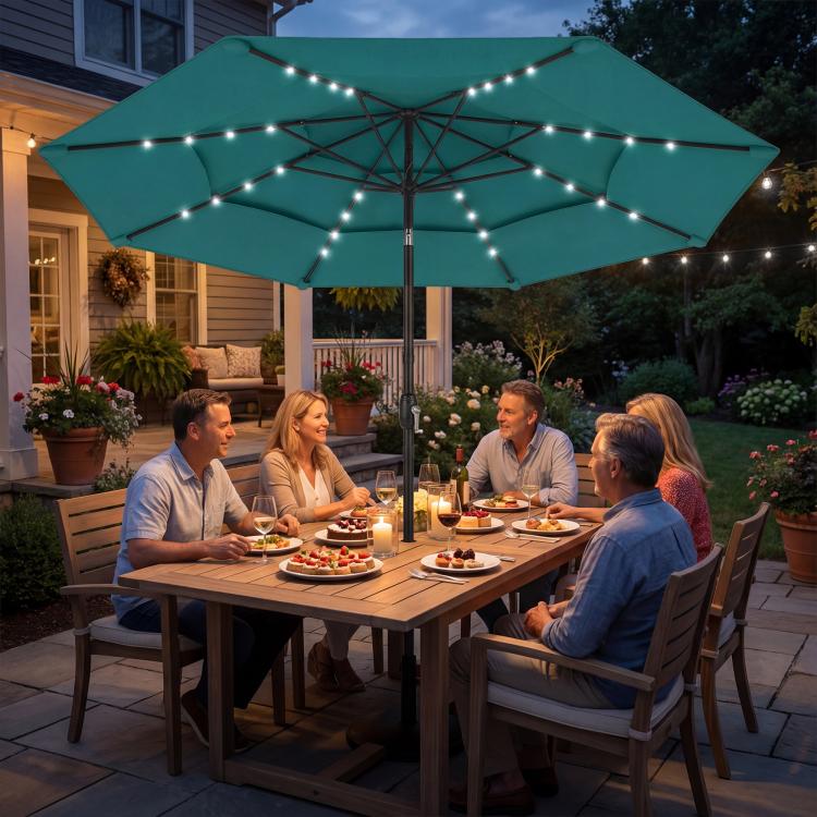 Teal three-tier patio umbrella with solar LED lights over outdoor dining scene