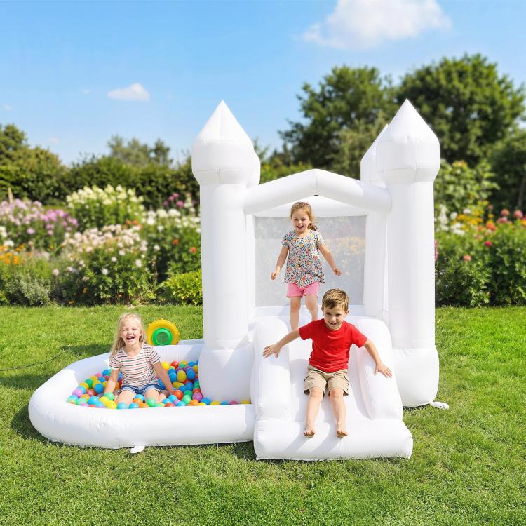 White inflatable castle bounce house with enclosed ramp and ball pit; kids playing