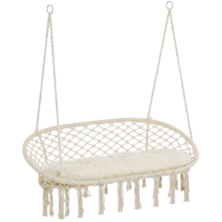 Two-person hanging macrame hammock chair with round net seat and beige cushion