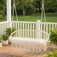 Outdoor hanging hammock chair with macrame net seat, cream cushion, and fringe ends