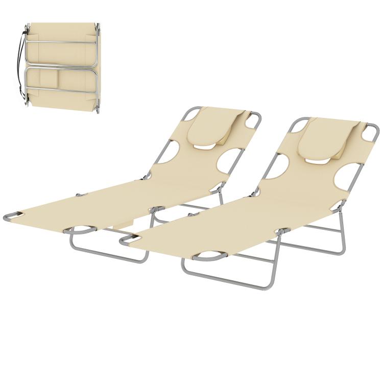 Two beige tanning chaise lounges, angled side view, with face pillows and steel frames