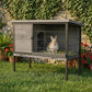Outdoor rabbit hutch on legs with open front and wire mesh enclosure; rabbit inside