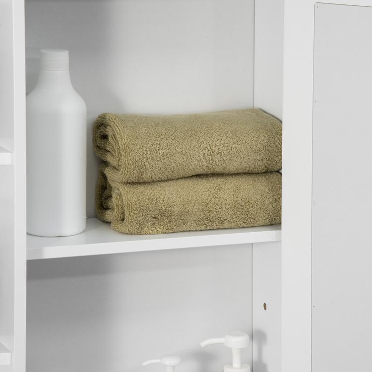 White bathroom medicine cabinet with mirror door and open shelves, folded towels