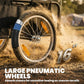 Close-up of 16-inch pneumatic wheel on black bike cargo trailer, with orange reflector