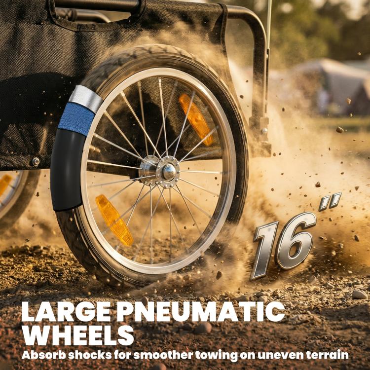 Close-up of 16-inch pneumatic wheel on black bike cargo trailer, with orange reflector