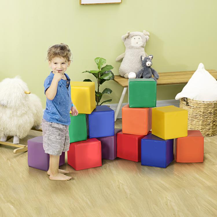 Multi-color foam cube blocks with two children playing near a stacked structure