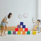 Colorful foam cube blocks on the floor in a balanced stacked arrangement