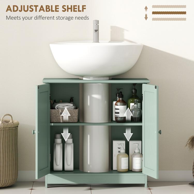 Green bathroom vanity cabinet with doors open and adjustable shelf holding bathroom items