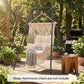 Black hammock chair stand holding a hanging hammock chair with two side chains