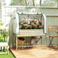 Silver raised garden bed with green greenhouse cover and lower storage shelf