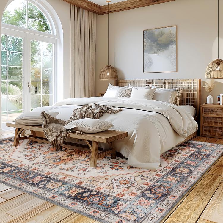 Boho medallion area rug in cream with navy and warm orange floral geometric pattern