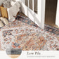Edge-close view of boho medallion area rug with cream, blue, and orange motifs