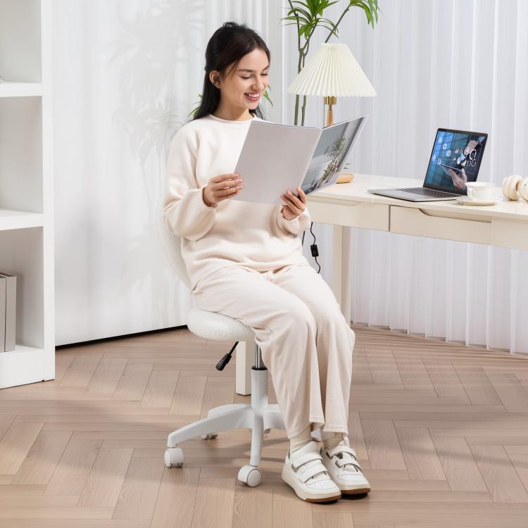 Woman seated on white armless teddy fleece chair with heart-shaped back cutout