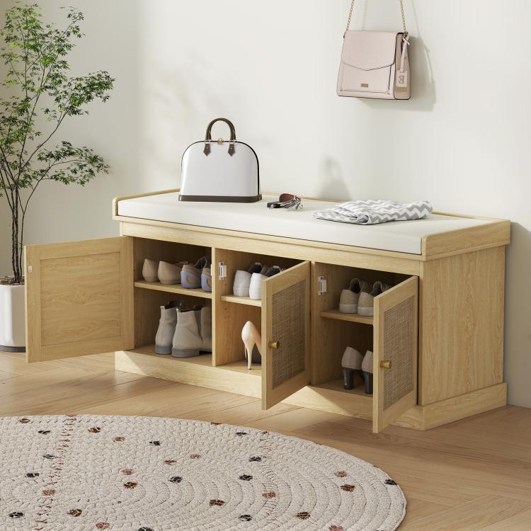 Shoe storage bench with cushioned top, open shelves, woven rattan door panels in oak tone
