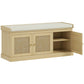 Shoe storage bench with cushioned top, woven rattan doors, open right shelves, oak tone