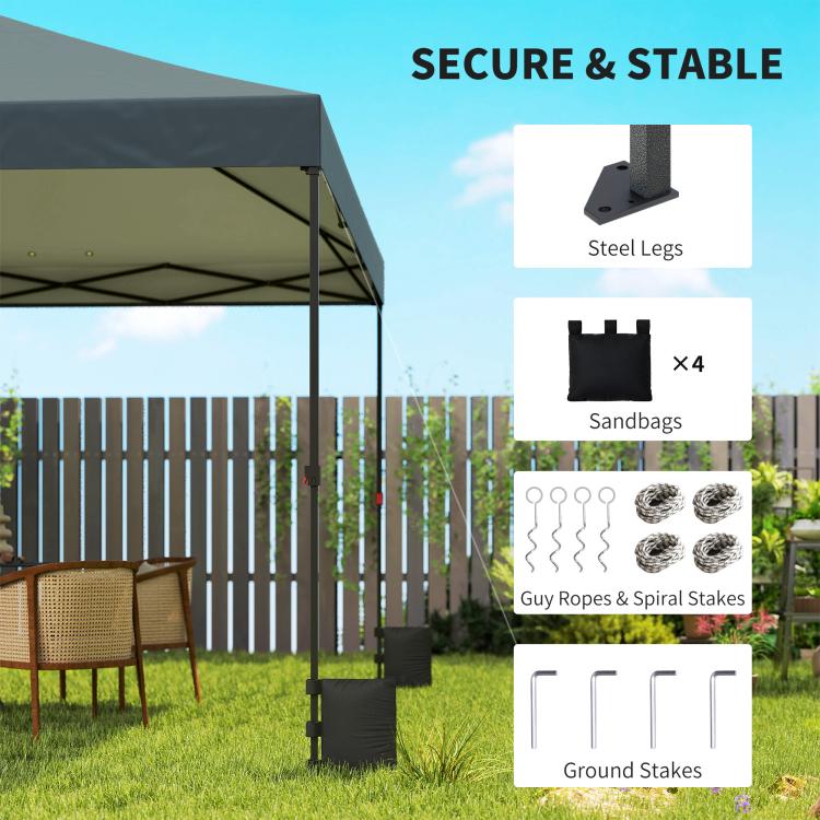 Dark gray canopy tent setup with steel legs, sandbags, and ground stakes