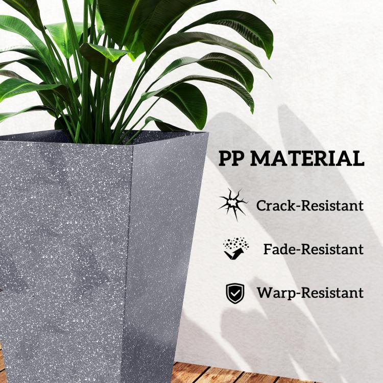Close-up of tall gray tapered plastic planter with green plant leaves