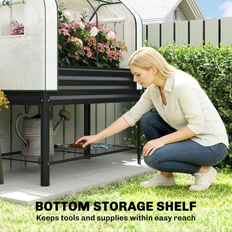 Raised garden bed with greenhouse cover and bottom storage shelf, showing tools underneath