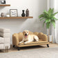 Beige cushioned pet sofa with curved back and armrests, dog resting on seat