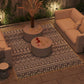 Outdoor rug carpet with black-and-white geometric pattern and bordered edges