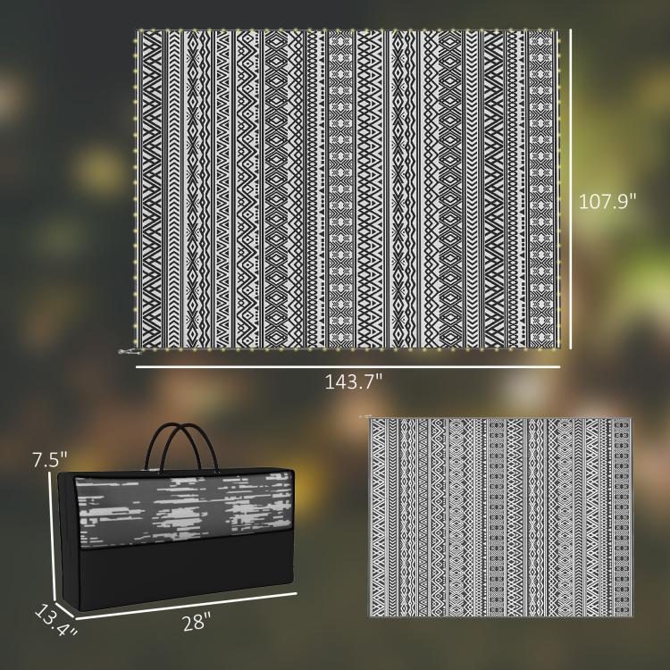 Outdoor rug carpet with black-and-white geometric pattern; folded bag shown