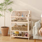 Wooden multi-level hamster cage with hut, ramp, and visible bedding floor
