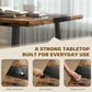 Brown tabletop with dark inlay band and black steel supports, close-up side view