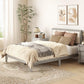 Gray platform bed with tufted upholstered headboard and beige throw blanket