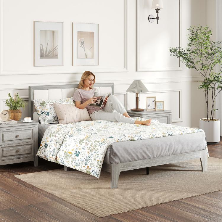 Gray platform bed with upholstered headboard and floral bedding set