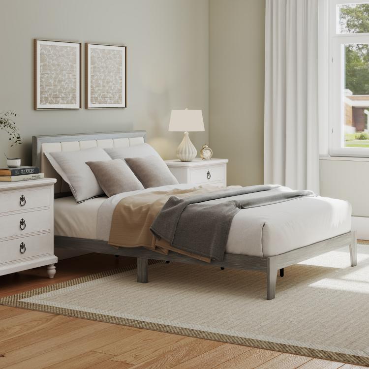 Gray full platform bed with upholstered headboard and neutral bedding