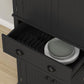 Black kitchen pantry cabinet with central drawer open and plates inside