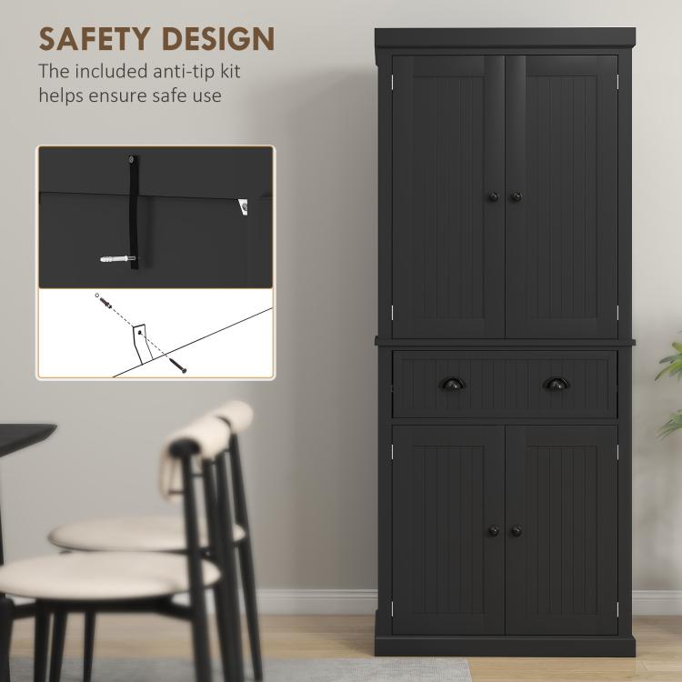 Black kitchen pantry cabinet with anti-tip bracket inset, doors closed