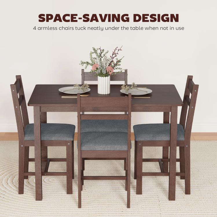 Dining table set with four upholstered armchairs tucked under the table