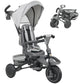 Gray kids tricycle with adjustable push handle, canopy, and reversible seat, angled view