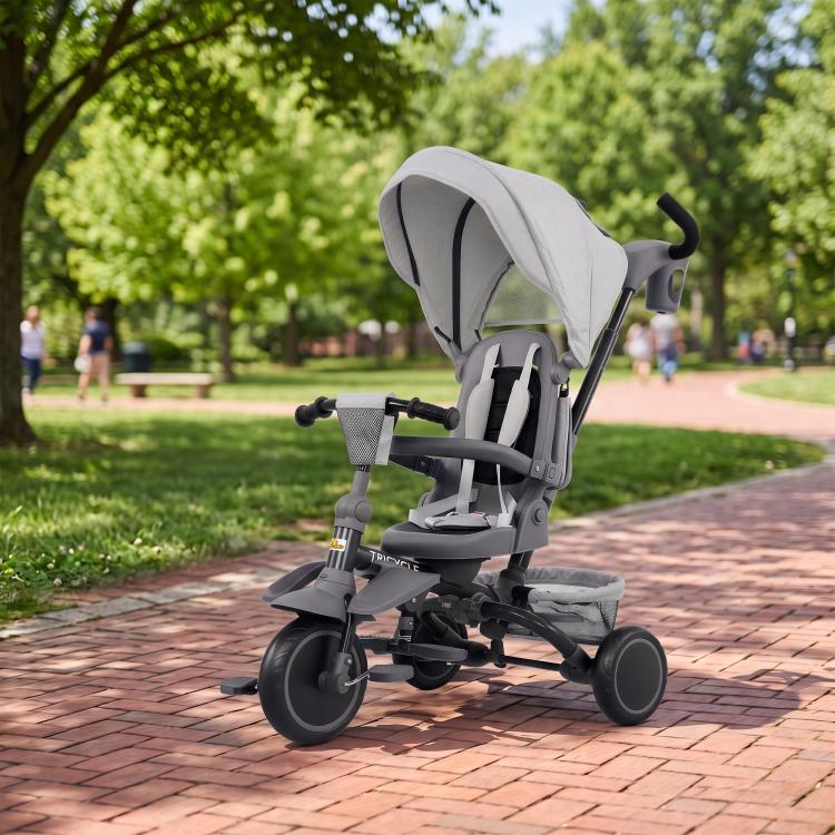 Gray kids tricycle stroller with canopy, front wheels, and three-wheel base