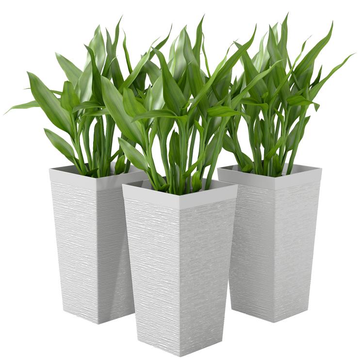 Set of three white stone-finish planters with upright plant-filled tops