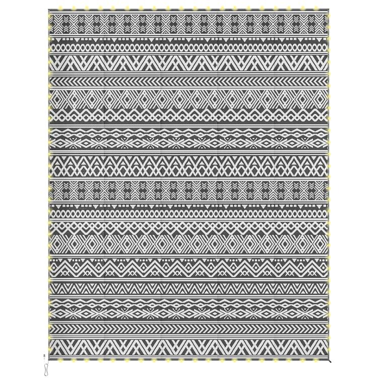Reversible patio rug with black-and-white geometric stripes and diamond motifs.