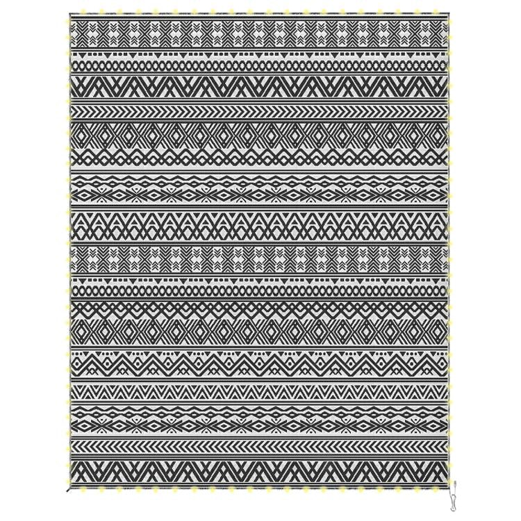 Reversible patio rug with black and white aztec-style pattern and fringe