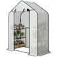 White greenhouse with green frame, open roll-up door with plants on black shelves